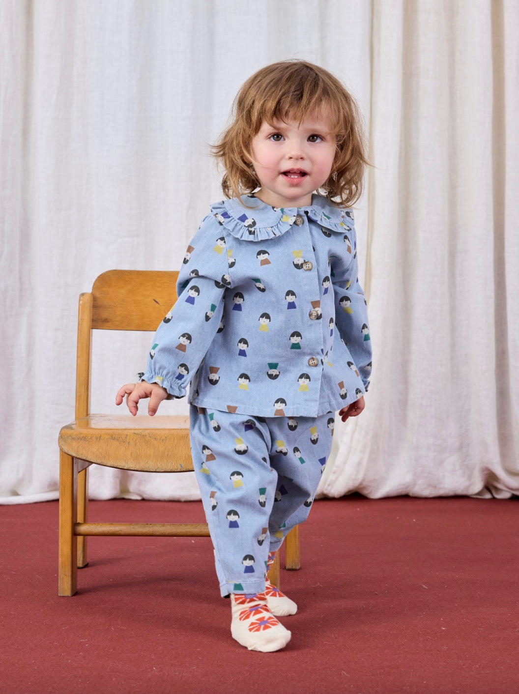 Game Pawns All Over Faces Print Button-Up Light Denim Blouse Light Blue